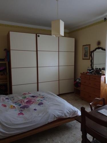 a bedroom with a large bed and a dresser at eleonora in Grottammare