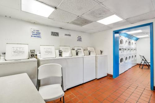 a room with a row of washing machines and a blue doorway at Yachtsman Oceanfront Resort in Myrtle Beach