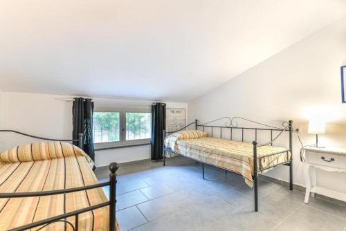 a bedroom with two bunk beds and a window at Casa Lydia in Rio nellʼElba