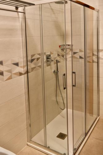 a shower with a glass door in a bathroom at L'Antica Fonte di Moncioveta in Bastia Umbra