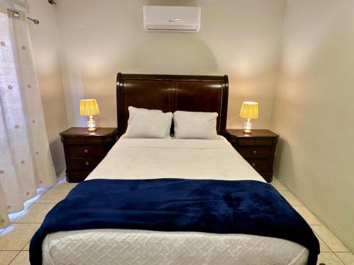 a bedroom with a large bed with two night stands at Exclusive Casa Platino Los Alamos in San Pedro Sula