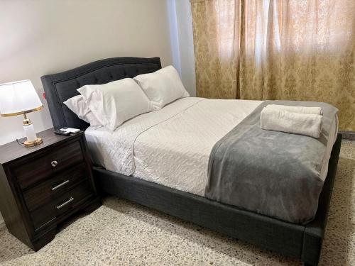 a bedroom with a large bed with a nightstand and a bed sidx sidx sidx at Exclusive Casa Platino Los Alamos in San Pedro Sula
