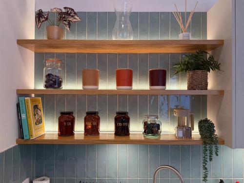 a shelf in a kitchen with jars on it at Old Library Apartments 8b in Orkney