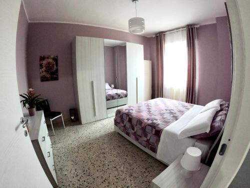 a bedroom with a bed and a large mirror at A due passi dalla Certosa in Certosa di Pavia