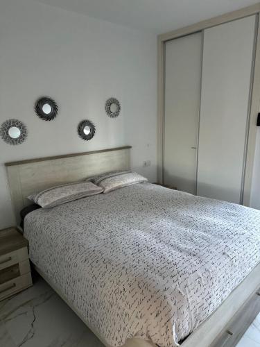 a bedroom with a bed with two mirrors on the wall at Guacimeta in Los Pocillos