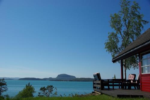 a cabin with a view of the water at Koselig feriehus ved fjorden med panorama utsikt in Hjelmeland