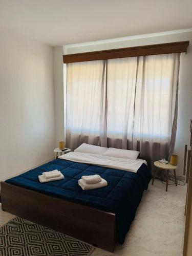 a bedroom with a bed with two towels on it at Cozy apartment comfy 1 in Serres