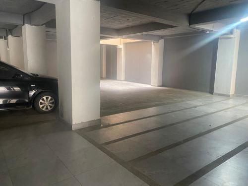 a parking garage with a car parked in it at Stelar Hostal in Cuenca