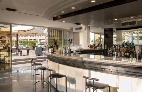 a bar in a restaurant with stools at Fantinello Hotel in Caorle