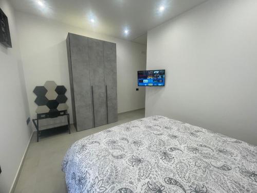 a bedroom with a bed and a tv on the wall at Dream Suite Bologna in Bologna