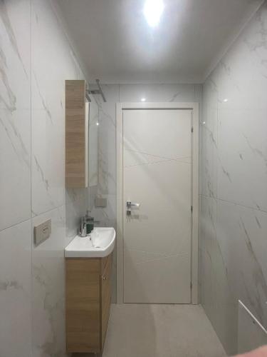 a white bathroom with a shower and a sink at Dream Suite Bologna in Bologna