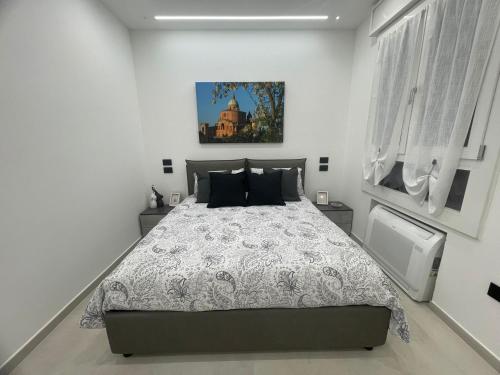 a bedroom with a bed and a picture on the wall at Dream Suite Bologna in Bologna