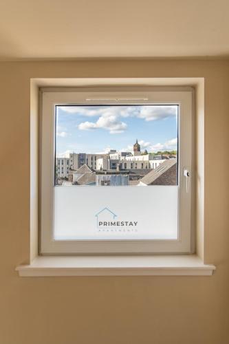 a window with a picture of a city at Prime Stay Apartments in Paisley