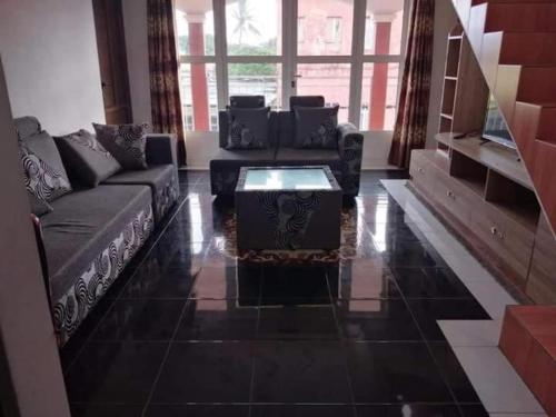 a living room with a couch and a coffee table at Anand Villa in Plaine Magnien
