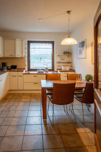 a kitchen with a table and chairs and a window at Ferienhaus Olbernhau 4 Sterne - Familie Walther in Olbernhau