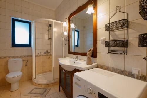 a bathroom with a sink and a toilet and a shower at Villa Lira The Hidden Gem Above the Sea in Rethymno Town