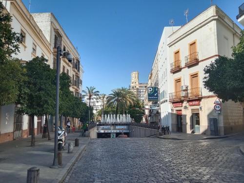 a cobblestone street in a city with buildings at Top Ático estudio Plaza del Arenal - Terraza con vistas in Jerez de la Frontera