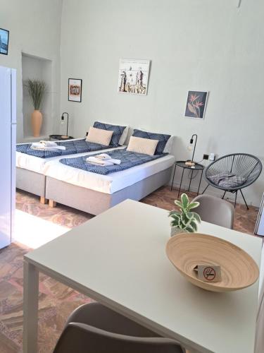 a living room with a bed and a table at Garden Rooms in Pírgos Psilonérou