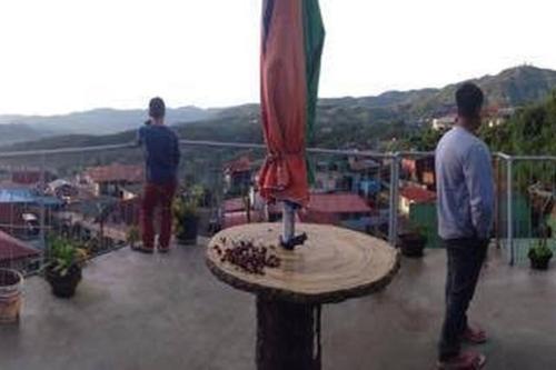 two men standing on top of a roof at De Hagan Transient Baguio City in Baguio