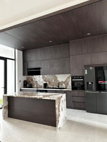 a kitchen with a marble counter top in a room at Villa Golf Novaworld in Bình Sum