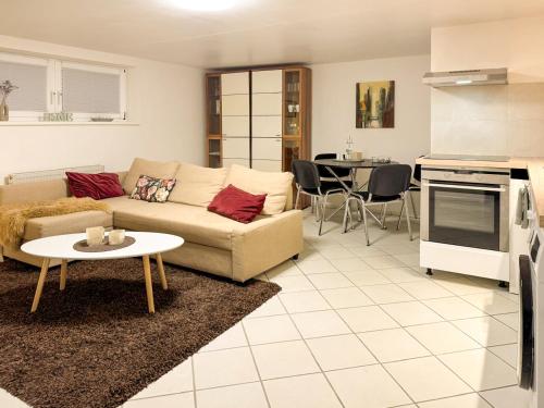 a living room with a couch and a table at FeWo Butzbachliebe in Butzbach