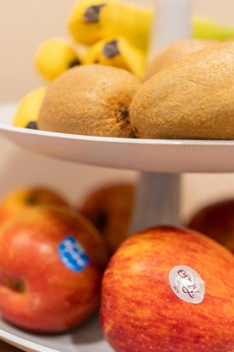 two plates of apples and bananas and other fruit at B&B La Residenza del Maestro - Catania Centro Storico in Catania