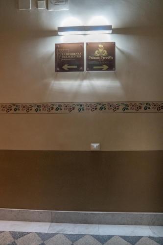 a wall with two signs on a wall at B&B La Residenza del Maestro - Catania Centro Storico in Catania