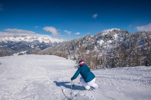 a person is skiing down a snow covered slope at Zeffereralm in Forstau
