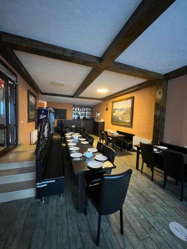 a dining room with a long table and chairs at Soncho Gudauri in Gudauri