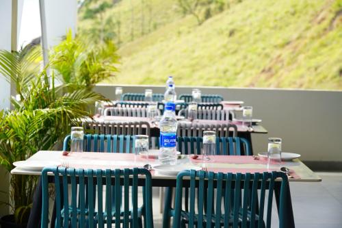 a row of tables with bottles of water on them at The Clouds End in Devikolam