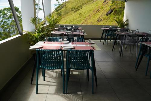 a row of tables and chairs in a restaurant at The Clouds End in Devikolam