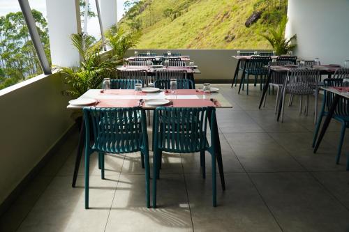 a row of tables and chairs in a restaurant at The Clouds End in Devikolam