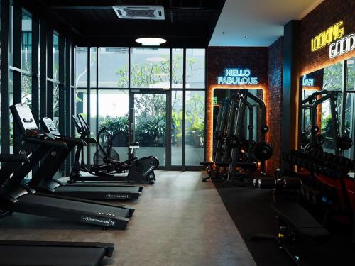 a gym with several treadmills and machines in it at Free Netflix Soho at Meta City for 2 Pax in Seri Kembangan