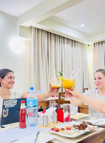 a group of people sitting at a table with drinks at Skylark Hotel in Karatu
