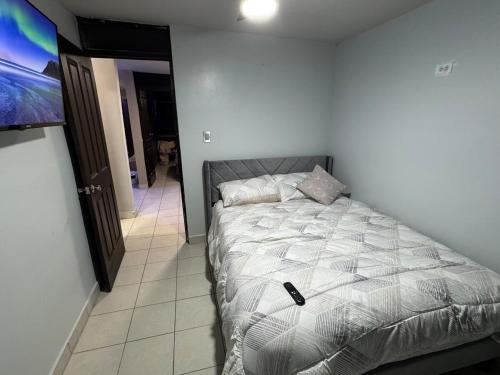a bedroom with a bed and a television on a wall at Casa Sonora Dunas Secure Parking in San Luis Río Colorado