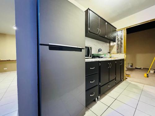 a kitchen with a stainless steel refrigerator at Casa Sonora Dunas Secure Parking in San Luis Río Colorado
