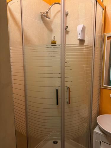 una ducha con puerta de cristal en un baño en Guest House Bike & Relax Finale Ligure, en Finale Ligure