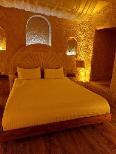 a bedroom with a large bed in a room at Grand Uchisar Hotel in Uchisar