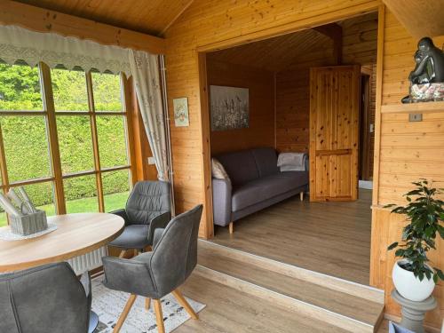 a living room with a couch and a table and chairs at Ferienhaus Kumpitsch in Sankt Johann im Saggautal