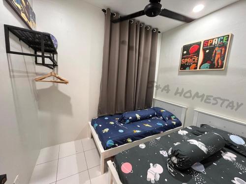 a bedroom with two twin beds and a poster on the wall at S&A Homestay in Sungai Petani