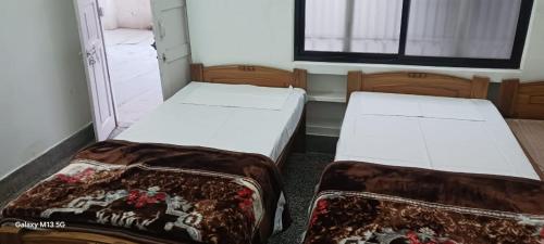 Ένα ή περισσότερα κρεβάτια σε δωμάτιο στο Geetanjali Home Stay