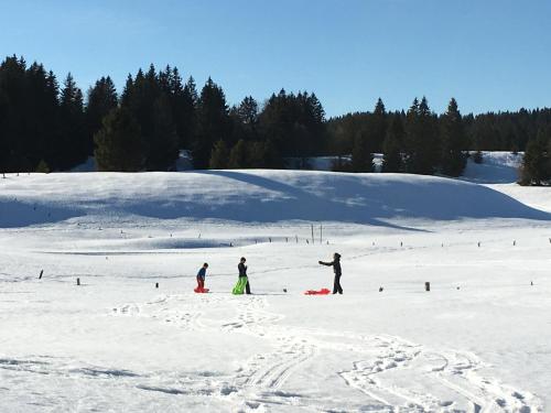 a group of people standing in the snow at Gîte La Petite Grange - En pleine nature ressourcement et randonnée in La Pesse