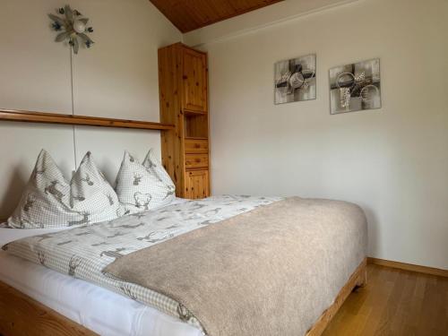 a bedroom with a bed with white sheets and pillows at Ferienhaus Kumpitsch in Sankt Johann im Saggautal