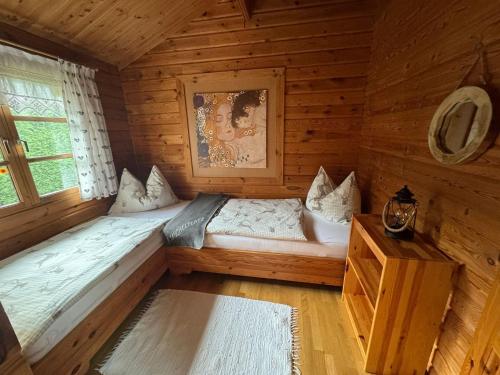 a room with two beds in a log cabin at Ferienhaus Kumpitsch in Sankt Johann im Saggautal