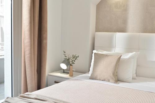 a bedroom with a white bed and a window at Alekos Apartments 2 Netflix, Self Check-In in Athens