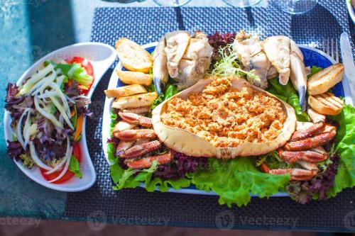 a plate of food with a sandwich and a salad at Quarteira Stylish 3 with Pool by Homing in Quarteira