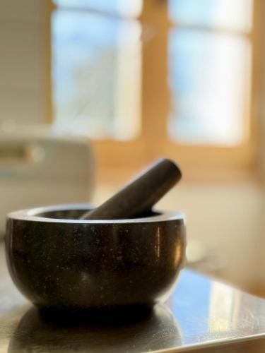 a black bowl sitting on a counter with a knife at Chambres d'hôtes au Château de Gandillac in Saint-Martial-Viveyrol