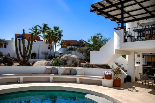 a swimming pool in front of a villa at Apartment near the beach with terrace #10 in Cabo San Lucas