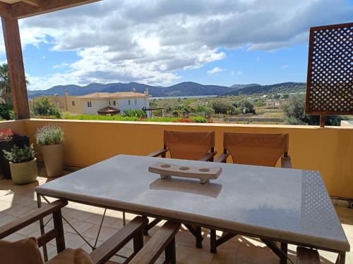 a table and chairs on a balcony with a view at Lida Garden Loft in Anavissos