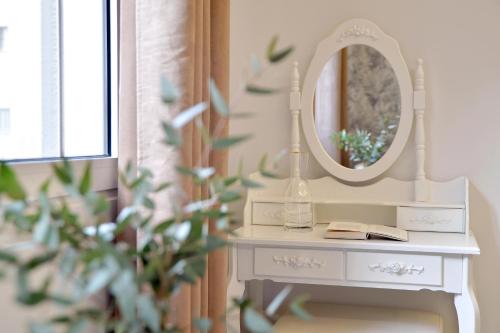 a white dressing table with a mirror on it at Alekos Apartments 2 Netflix, Self Check-In in Athens